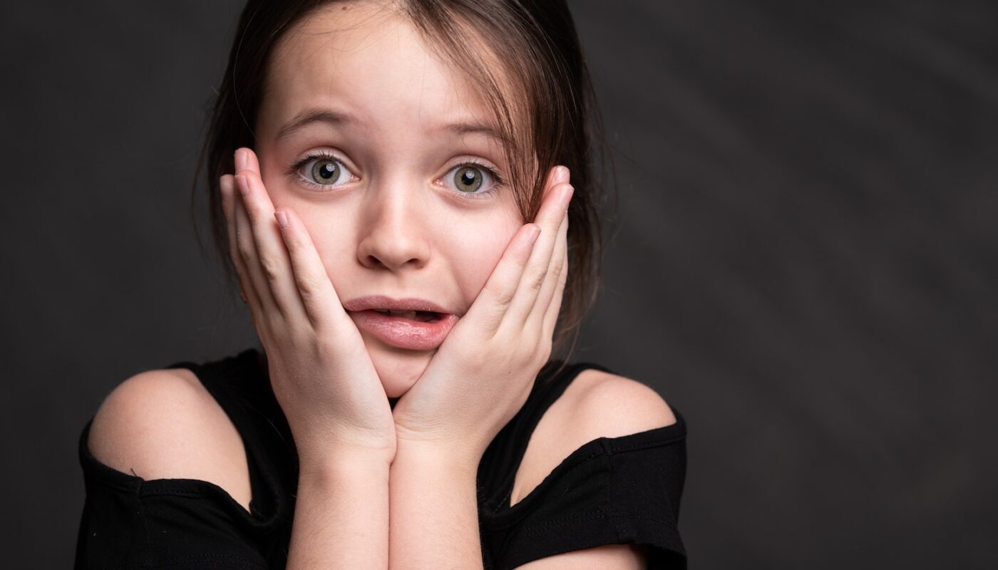 Girl in Black Top Looking Surprised